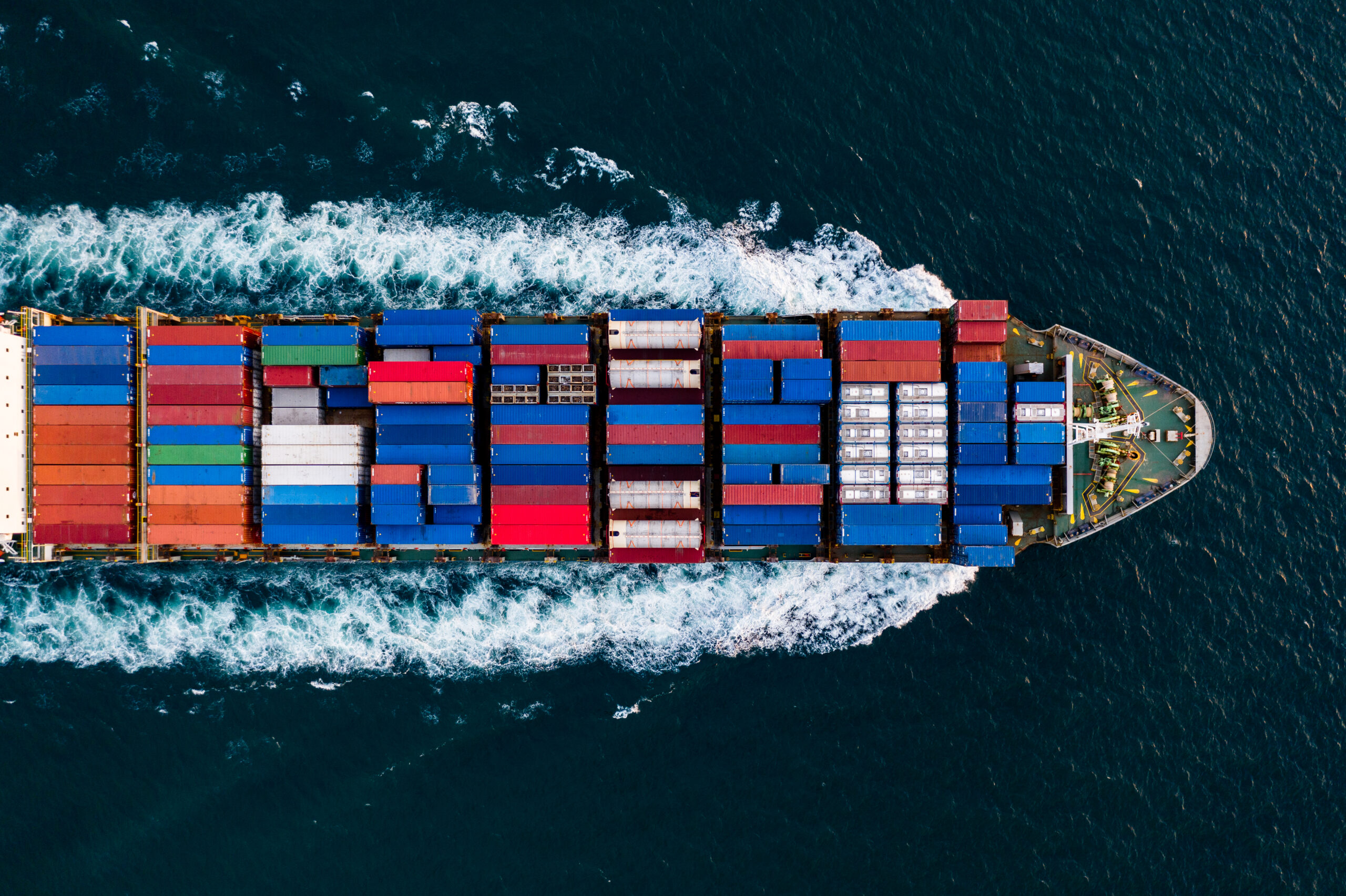 container cargo logistics shipping import export industry and business service transportation of international by container cargo freight ship open in deep sea aerial top view from drone photography